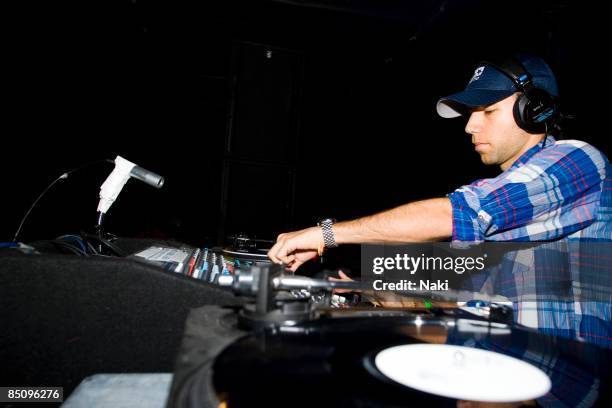 Photo of TIGA, Canadian DJ Tiga performing on stage, record decks