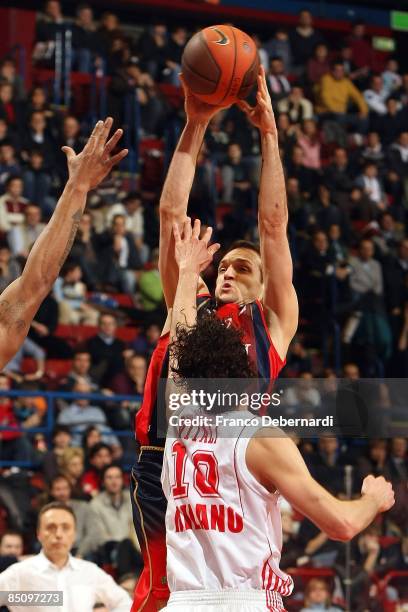 Igor Rakocevic, #8 of TAU Ceramica competes with Luca Vitali, #10 of AJ Milano during the Euroleague Basketball Last 16 Game 4 match between Armani...