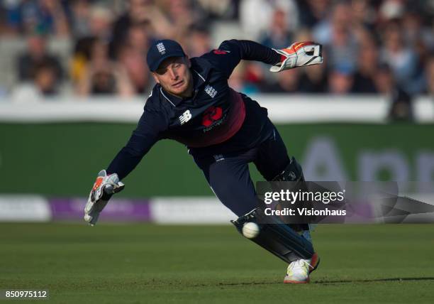 England wicketkeeper Jos Buttler dives to stop the ball during the Royal London One Day International between England and the West Indies at Old...
