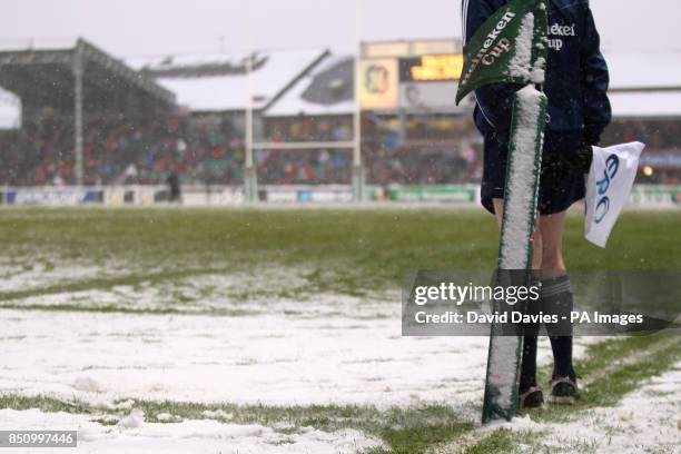 The touch judge next to the snow covered corner flag during the Heineken Cup Pool 2 match at Welford Road, Leicester.
