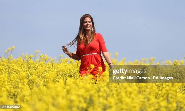 Magda Tatar walks through a field of oilseed rape on the farm of Edward Whyte in Naul, Co Dublin, as temperatures continue to rise across the country.