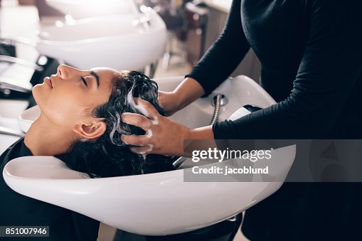 Woman getting hair shampooed at salon Woman getting hair shampooed at salon