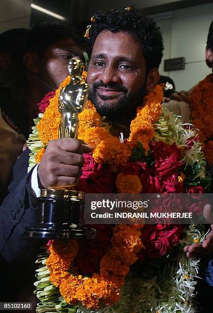 "Slumdog Millionaire" Indian sound engineer, Resul Pookutty, displays his golden Oscar statue after arriving back from the Oscars at the airport in...