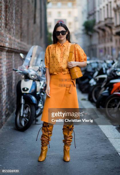 Doina Ciobanu wearing yellow orange blouse and skirt, noots is seen outside Max Mara during Milan Fashion Week Spring/Summer 2018 on September 21,...