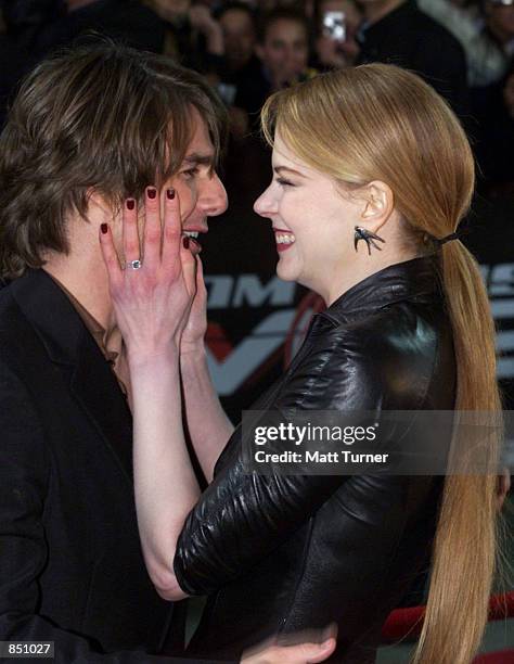 Actor Tom Cruise and his wife Nicole Kidman embrace each other at the Sydney premiere of "Mission Impossible 2" May 30, 2000 at Fox Studios in...