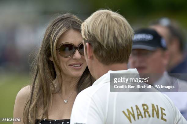 Elizabeth Hurley with her partner Shane Warne at Cirencester Park in Gloucestershire, for a charity 20/20 Cricket for Kids match, England vs...