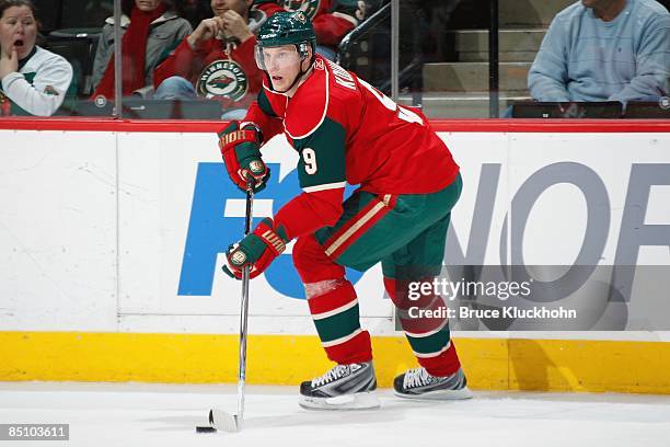 Mikko Koivu of the Minnesota Wild handles the puck along the boards against the Detroit Red Wings during the game at the Xcel Energy Center on...