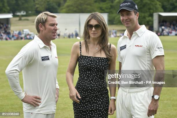 Elizabeth Hurley flips the coin for the toss with team captains England's Michael Vaughan and partner, Australia's Shane Warne, before play at...