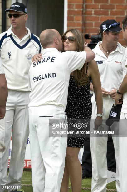 Elizabeth Hurley kisses Jeremy Snape as she arrives at Cirencester Park in Gloucestershire, for a charity 20/20 Cricket for Kids match, England vs...