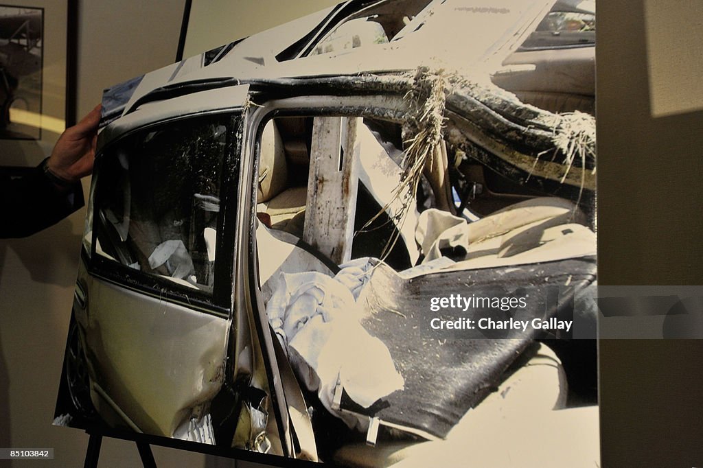 Photos of the car wreck are shown to the press at a press conference