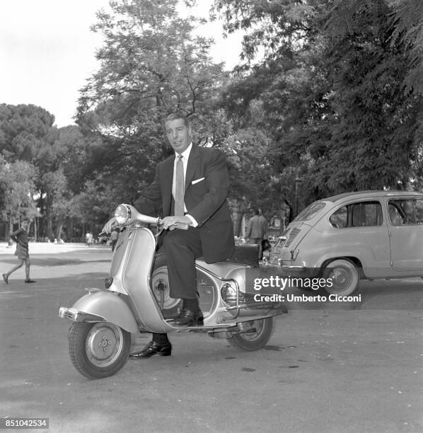 Rome, Italy, June 13, 1957. Joe Di Maggio, baseball champion and former husband of Marilyn Monroe, rides a Vespa scooter, a symbol of the Italian...