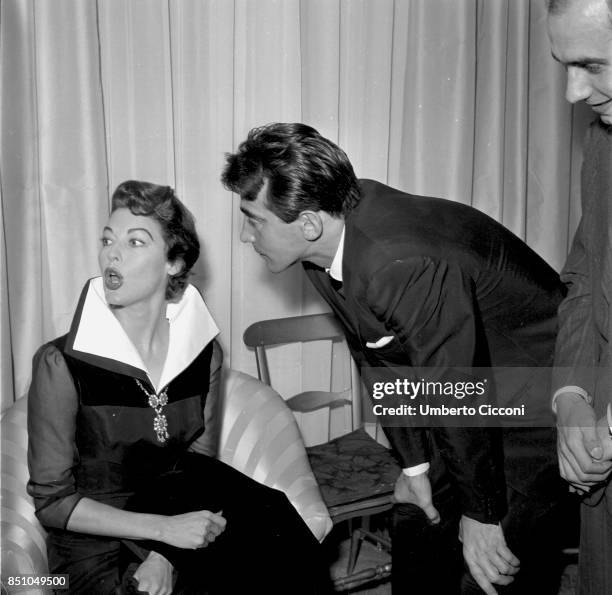 Rome, Italy, March 21, 1957. American actress Ava Gardner in the Sorelle Fontana fashion house with the Italian actor Walter Chiari