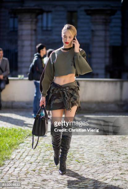 Hannah Ferguson wearing US Army cropped top, camouflage skirt, boots is seen outside Max Mara during Milan Fashion Week Spring/Summer 2018 on...
