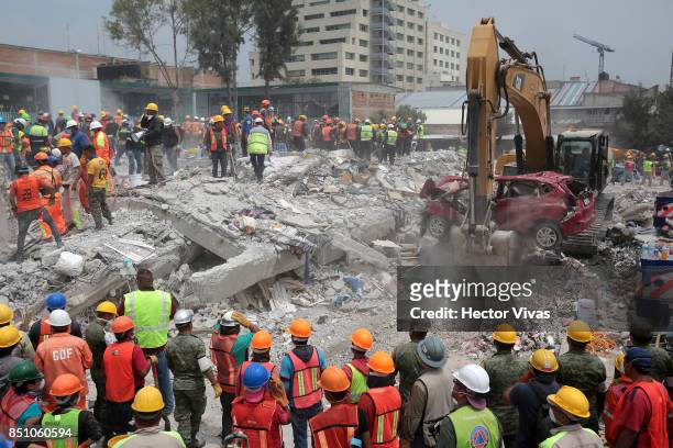 Rescuers and volunteers work in a textile factory that collapsed, two days after the magnitude 7.1 earthquake jolted central Mexico killing more than...