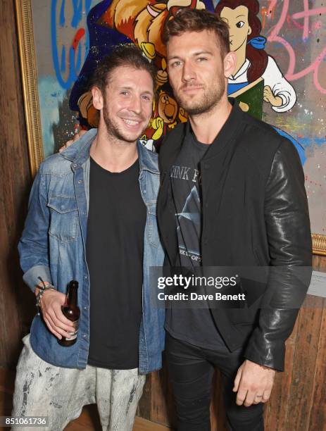 Robyn Ward and Alex Pettyfer attend a private view of new exhibition "A Simpler Time " by artist Robyn Ward at the Old Chappell Piano Factory on...