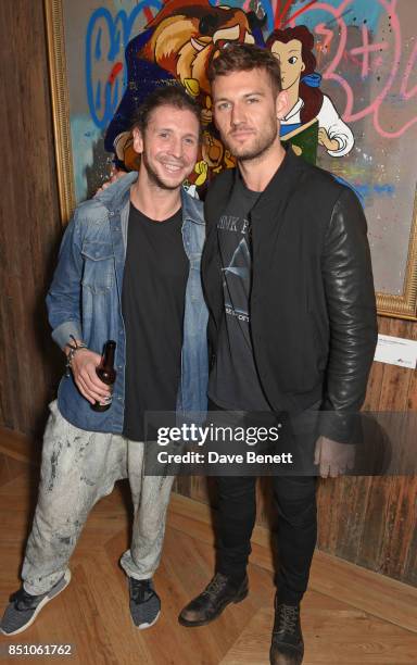 Robyn Ward and Alex Pettyfer attend a private view of new exhibition "A Simpler Time " by artist Robyn Ward at the Old Chappell Piano Factory on...