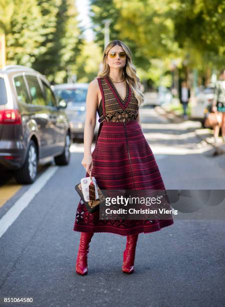 Thassia Naves wearing a red dress is seen outside Fendi during Milan Fashion Week Spring/Summer 2018 on September 21, 2017 in Milan, Italy.