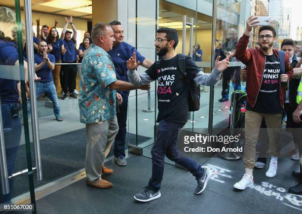 Mazzen Kaourouche, who had been queueing for eleven days with his two friends, is first allowed inside for the release of the iPhone 8 and 8 Plus at...