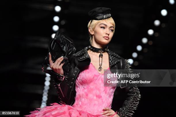 Model Gigi Hadid presents a creation for fashion house Moschino during the Women's Spring/Summer 2018 fashion shows in Milan, on September 21, 2017....