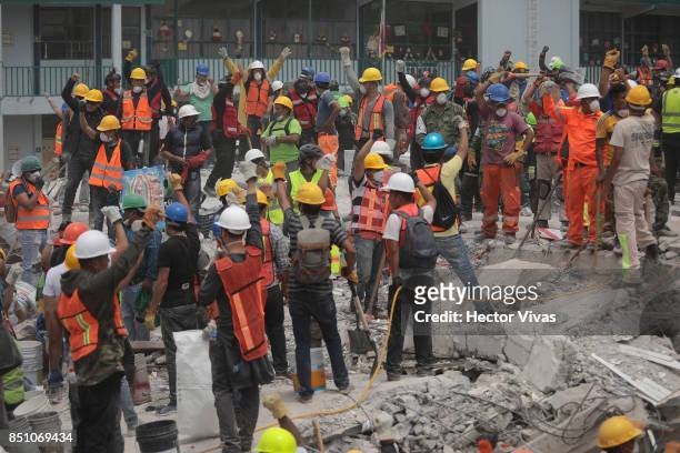 Rescuers and volunteers work in a textile factory that collapsed two days after the magnitude 7.1 earthquake jolted central Mexico killing more than...