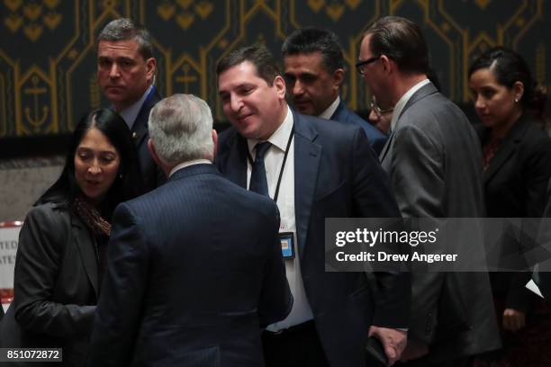 Russian Deputy Permanent Representative to the United Nations Vladimir Safronkov shakes hands with U.S. Secretary of State Rex Tillerson at the...