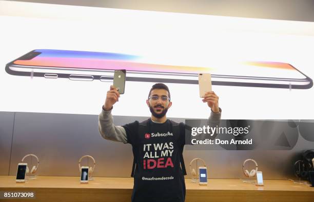 Mazzen Kaourouche, who had been queueing for eleven days with his two friends, displays the iPhone 8 and 8 Plus at Apple Store on September 22, 2017...