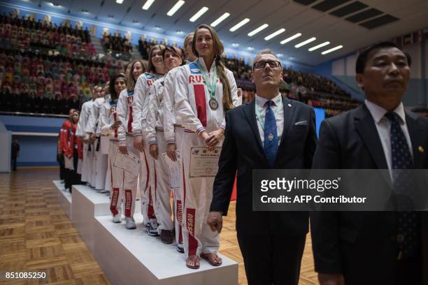 In a photo taken on September 21, 2017 team members from North Korea and Russia stand on the podium of during the medal ceremony of womens team event...