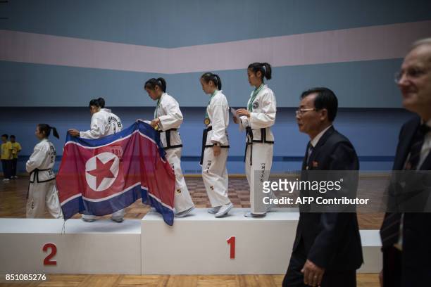 In a photo taken on September 21, 2017 team members from North Korea leave the podium of during the medal ceremony of womens team event after taking...