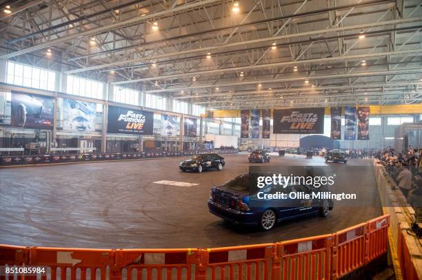 The shows stunt drivers giving a demonstration of driving from a scene in the peformance during the 'Fast & Furious Live' media launch day event on...