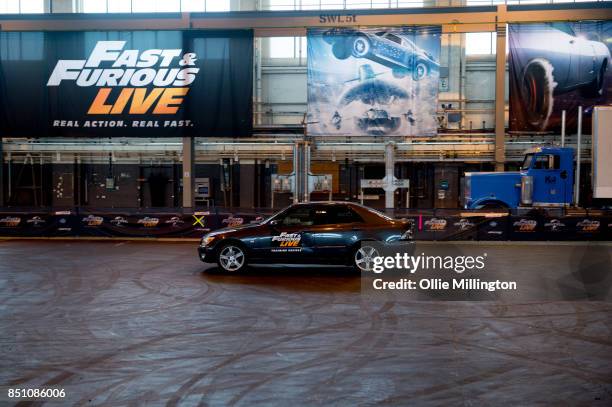 The shows stunt drivers giving a demonstration of driving from a scene in the peformance during the 'Fast & Furious Live' media launch day event on...