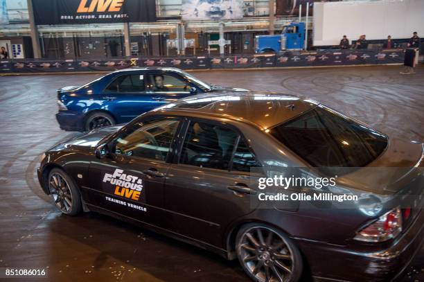 The shows stunt drivers giving a demonstration of driving from a scene in the peformance during the 'Fast & Furious Live' media launch day event on...