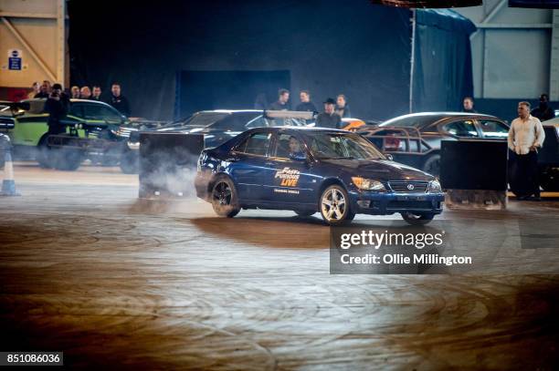 The shows stunt drivers giving a demonstration of driving from a scene in the peformance during the 'Fast & Furious Live' media launch day event on...