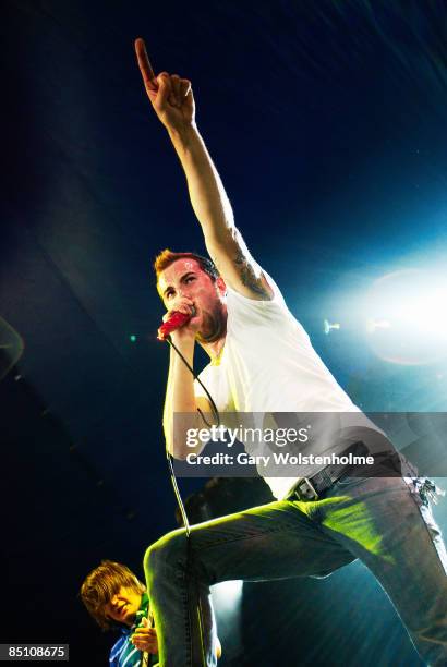 Photo of AUGUST BURNS RED and Jake LUHRS, Jake Luhrs performing on stage, pointing