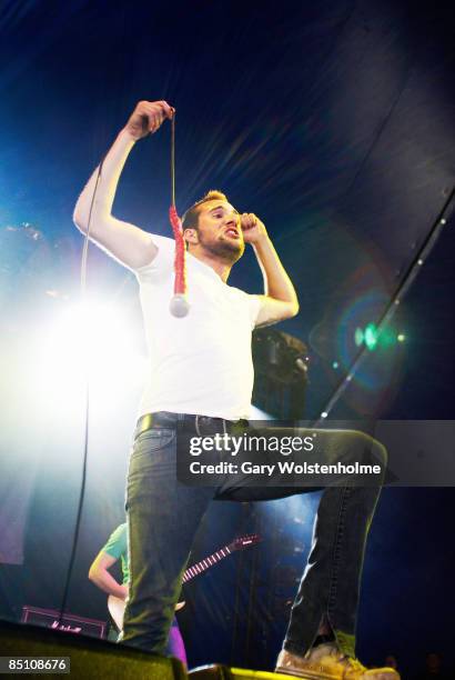 Photo of AUGUST BURNS RED and Jake LUHRS, Jake Luhrs performing on stage, swinging microphone