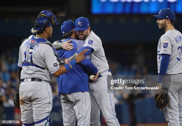 Peter Moylan of the Kansas City Royals hugs manager Ned Yost as he is relieved in the seventh inning during MLB game action against the Toronto Blue...