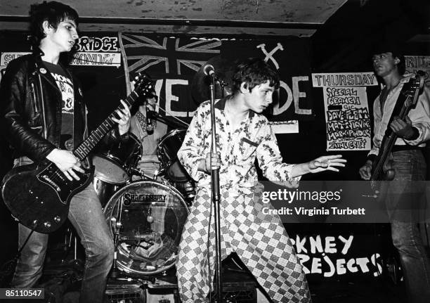 Photo of COCKNEY REJECTS and Mick GEGGUS and Andy SCOTT and Jeff TURNER and Vince RIORDAN; Group performing on stage L-R Mick Geggus, Andy Scott,...