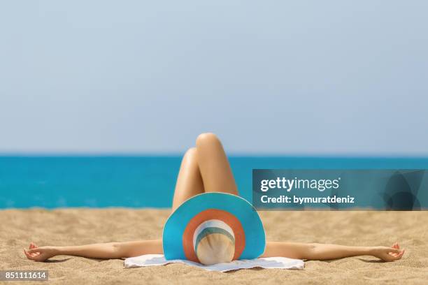 relaxing and sunbathing at beach - tanned body stock pictures, royalty-free photos & images