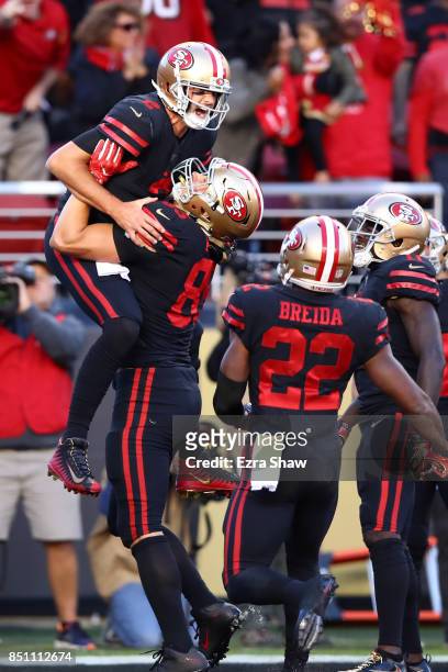 Brian Hoyer of the San Francisco 49ers celebrates after rushing for a touchdown in the first quarter against the Los Angeles Rams at Levi's Stadium...
