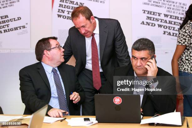 Labour's Rongotai candidate Paul Eagle makes a campaign call while MPs Grant Robertson and Andrew Little talk during a visit to Eagle's phone bank on...