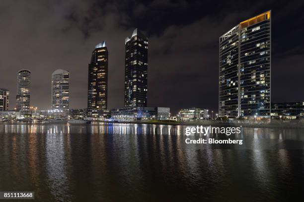 Residential buildings stand at night in the Docklands area of Melbourne, Australia on Thursday, July 20, 2017. Melbournes tax of 1 percent of an...