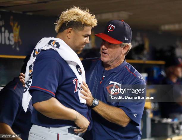 Starting pitcher Adalberto Mejia of the Minnesota Twins talks with pitching coach Neil Allen of the Minnesota Twins after leaving the game with a 4-1...