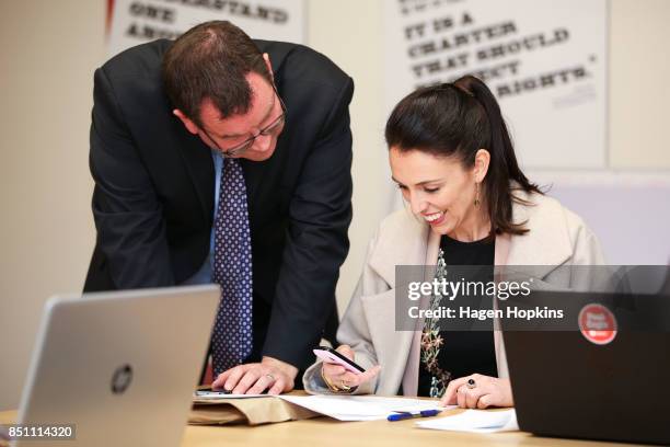 Labour leader Jacinda Ardern prepares to make a campaign call while fellow MP Grant Robertson looks on during a visit to Rongotai candidate Paul...