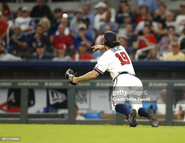 Pitcher R.A. Dickey of the Atlanta Braves throws to first base for a putout in the seventh inning during the game against the Washington Nationals at...