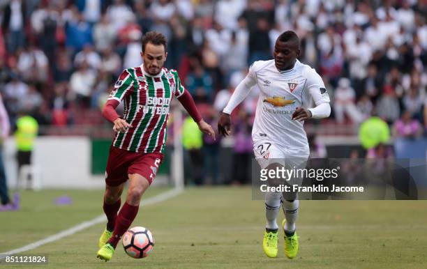 Lucas Marquez of Fluminense struggles for the ball with Jonathan Betancourt of LDU Quito during a second leg match between LDU Quito and Fluminense...