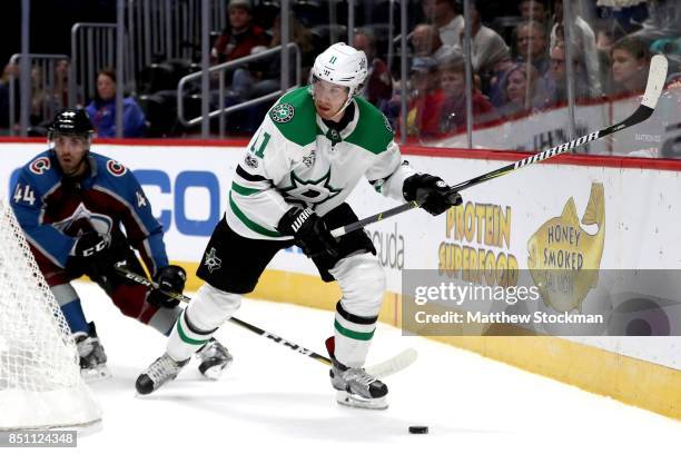 Curtis McKenzie of the Dallas Stars handles the puck against Mark Barberio of the Colorado Avalanche at the Pepsi Center on September 21, 2017 in...