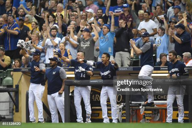 The Milwaukee Brewers bench and left fielder Hernan Perez , shortstop Orlando Arcia celebrate after scoring during a game between the and the Chicago...