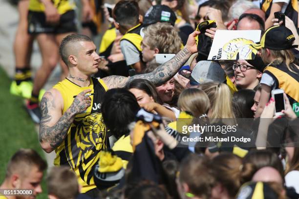 Dustin Martin of the Tigers signs autographs for fans during a Richmond Tigers AFL training session at Punt Road Oval on September 22, 2017 in...
