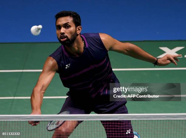 Prannoy of India hits a return towards Shi Yuqi of China during the men's singles quarter-final match at the Japan Open Badminton Championships in...