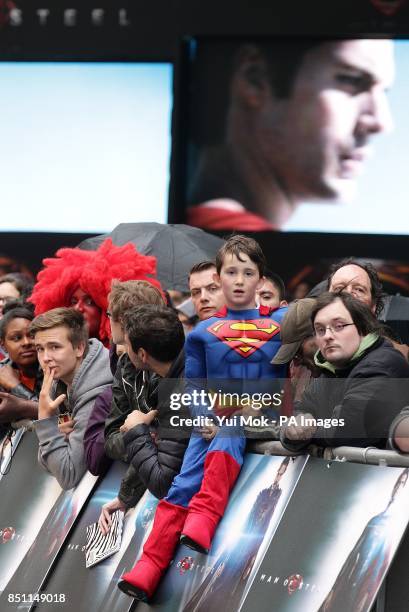 Young Superman fan in costume waits for the arrivals for the European premiere of Man of Steel at the Odeon Leicester Square, London