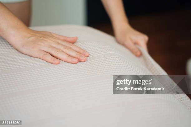 woman hands making a room bed - bettbezug stock-fotos und bilder